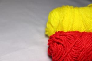 red and yellow colored yarn closeup photo