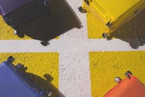 baggage luggage suitcase colorful placed on floor street concrete the square schedule color yellow. travel holiday summer concept and idea creative. Leave copy space empty to write a message. photo