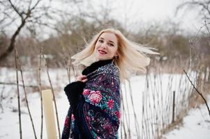 Blonde girl with hand embroidered scarf posed at winter day. Women's handkerchief. photo