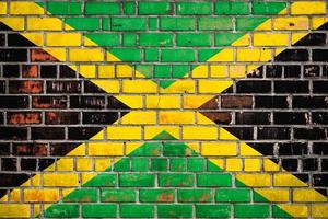 National  flag of the Jamaica  on a grunge brick background. photo