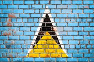 National  flag of the  Saint lucia on a grunge brick background. photo