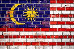 National  flag of the  Malaysia on a grunge brick background. photo