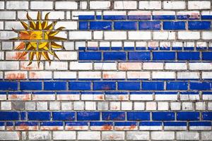 National  flag of the Uruguay on a grunge brick background. photo