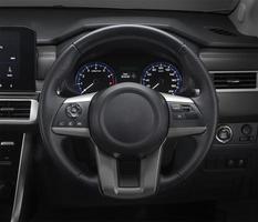 Inside the luxury car steering wheel, gear lever and dashboard. photo