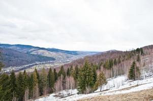 Snowy mountain valleys at Carpathian mountains. View of Ukrainian Carpathians and Yaremche from the top of Makovitsa. photo