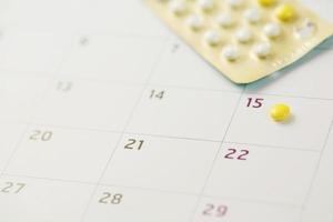 contraceptive control pills on date of calendar background. health care and medicine Birth control concept. photo