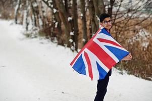 Stylish indian man in suit with Great Britain flag posed at winter day outdoor. photo