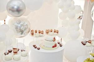 Candy bar decoration setup with delicious cakes and sweets. photo