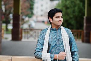 Indian man wear on traditional clothes with white scarf posed outdoor. photo