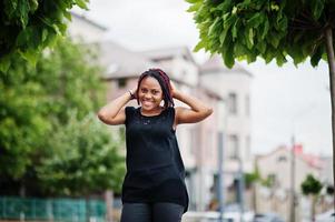 Young african american woman posed against fountain. photo