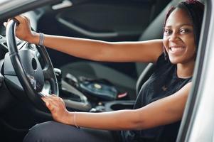 Portrait of young african american woman driving a car. photo