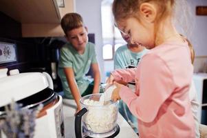 Kids cooking at kitchen, happy children's moments. photo