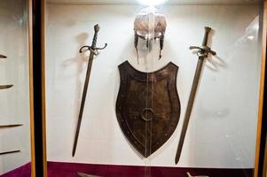 Medieval weapons or tools behind the glass in the museum. photo