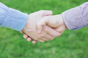 Close up of a business man hand shake between two colleagues greet , Represents Friendship is good,success, congratulations. copy leave space for text. photo