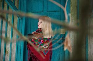 Blonde girl with hand embroidered scarf posed at winter day. Women's handkerchief. photo