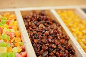 Raisins and candied fruits on the shelf of a supermarket or grocery store. photo