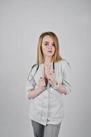 Blonde sexy doctor nurse with stethoscope isolated on white background. photo