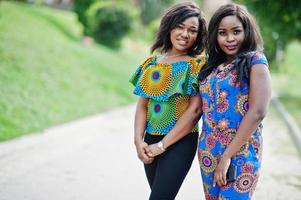 Two african american girls posed outdoor at park patch. photo