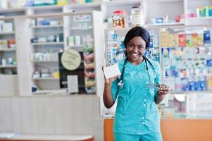 African american pharmacist working in drugstore at hospital pharmacy. African healthcare. photo