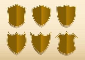 Set of gold shields of various shapes. Vector illustration