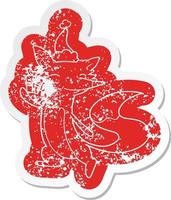 cartoon distressed sticker of a happy fox wearing santa hat vector