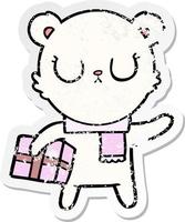 distressed sticker of a peaceful cartoon polar bear with christmas gift vector