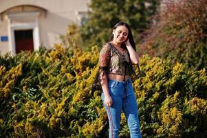 Pretty latino model girl from Ecuador wear on jeans posed at street. photo