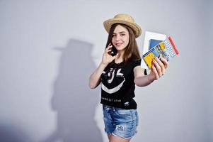 Girl tourist with warszawa map, wear in lol shirt, shorts and hat with mobile phone isolated on white. photo