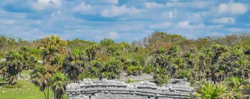 Ancient Tulum ruins Mayan site temple pyramids artifacts seascape Mexico. photo