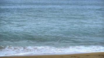 Azure waves rolled on the sand of Mai Khao Beach video