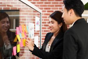 Two business people discussing working with a young Indian female worker on a project, people holding a video meeting with a client or interviewing a job candidate. photo