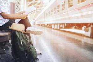 The passengers are stand waiting for the Station platform photo