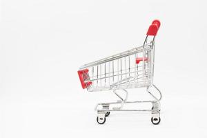 Empty grocery hand cart Shopping cart color red, Mini Supermarket Car Isolated On White Background photo