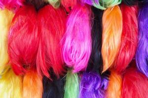 Close up Wig hairpiece colorful variety in wigs shop store. or sample Hair color dyes hair salon. photo