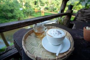 Breakfast tea and coffee on old wooden table photo