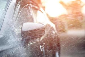 Car washing. Cleaning Car Using High Pressure Water. photo