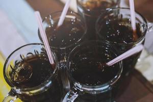 different many soft drink are in a glass on wooden table. sparkling water. Leave space to write descriptive text. photo