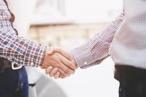 business and office concept - businessman shaking hands each oth photo