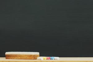 Blank Dark blackboard with color Chalk and eraser on the frame for drawing in Classroom. Horizontal composition. copy space empty Chalkboard Background. back to school. photo