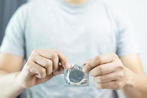 Man is using condoms to prevent AIDS. photo