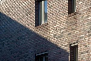 windows of a building in the sun with shadow photo