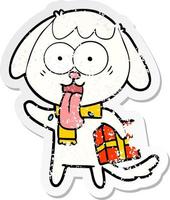 distressed sticker of a cute cartoon dog with christmas present vector