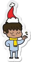 sticker cartoon of a happy boy wearing santa hat vector