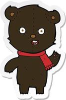 sticker of a cartoon waving black bear cub with scarf vector