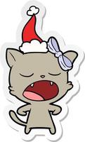 sticker cartoon of a yawning cat wearing santa hat vector