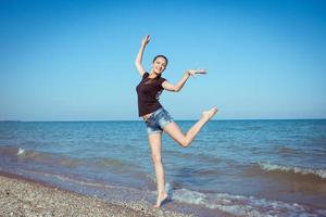 Young cheerful girl on the sea photo