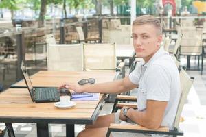 Young man sitting in cafe photo