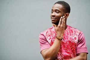 Portrait of a black young man wearing african traditional red colorful clothes. photo