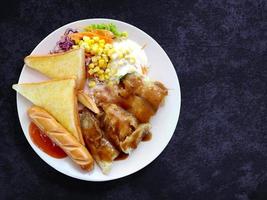 steak fish salad with sausage and toasted bread on plate, Top view food  and vegetable on background photo