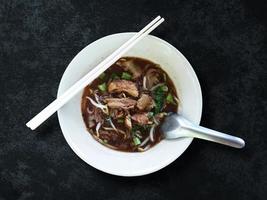 Beef noodle in white bowl, Top view soup meat style on white background, asian food isolated with clipping photo